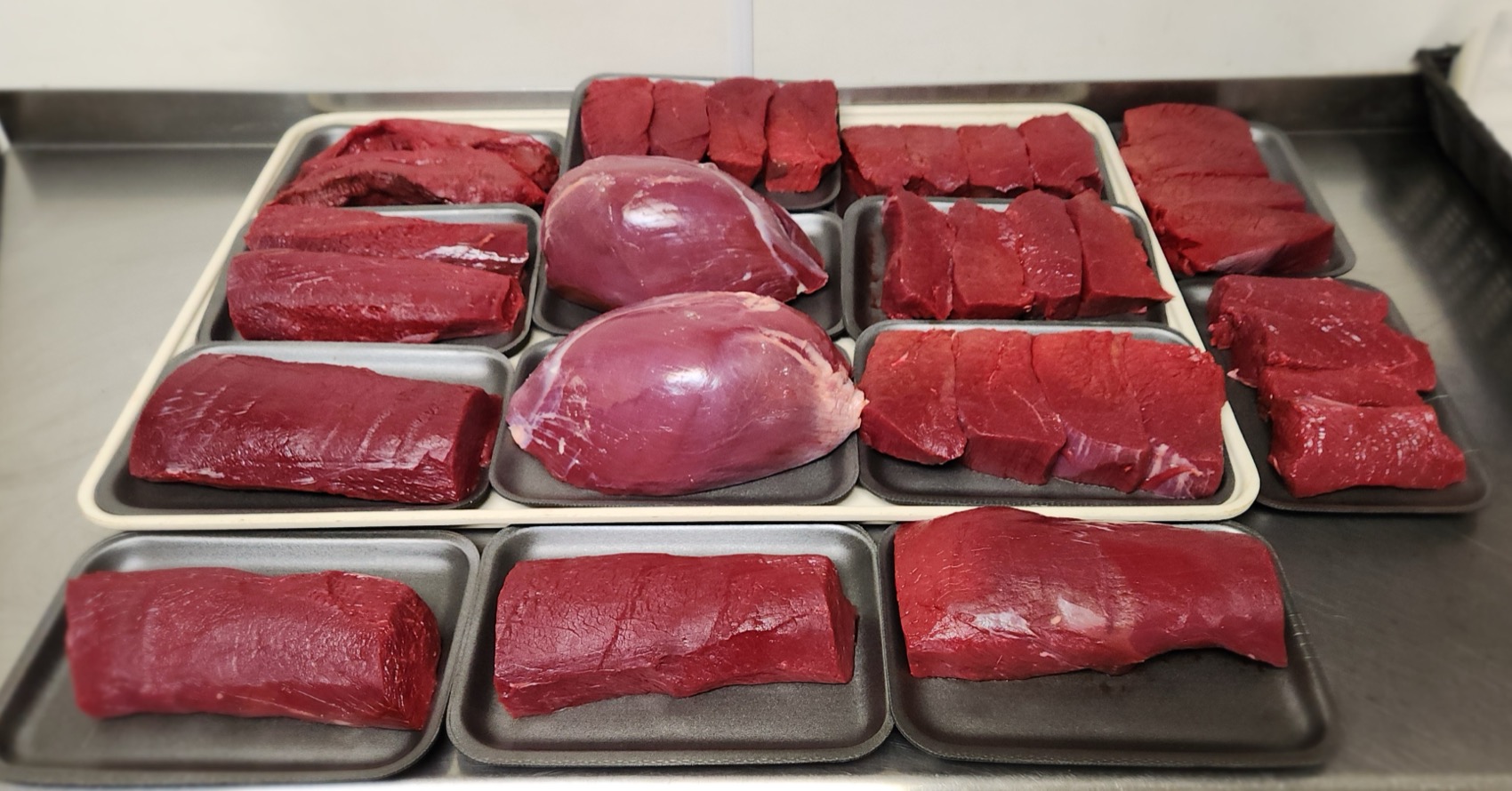 Venison cuts — backstraps, steaks, roasts and tenderloins trayed and ready to package